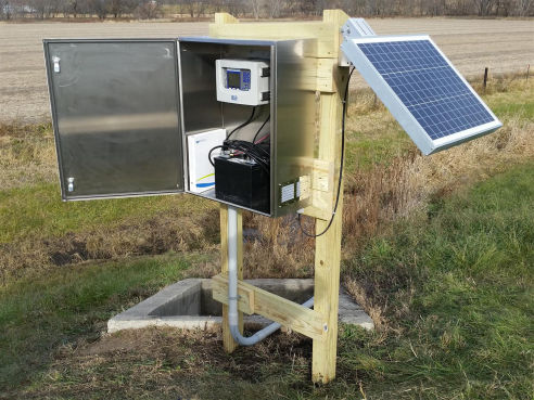Guthrie Center IA - treated lumber structure, stainless enclosure, solar panel, and Teledyne ISCO Signature ultrasonic flow meter