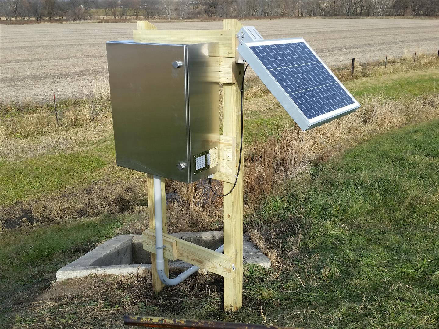 Guthrie Center IA - treated lumber structure, stainless enclosure, solar panel, and Teledyne ISCO Signature ultrasonic flow meter