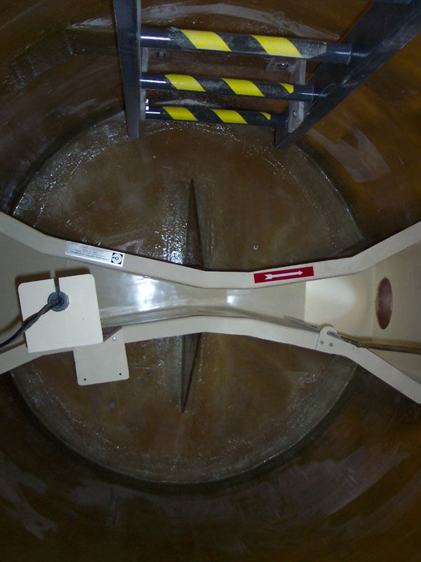A fiber reinforced plastic flume in a metering manhole